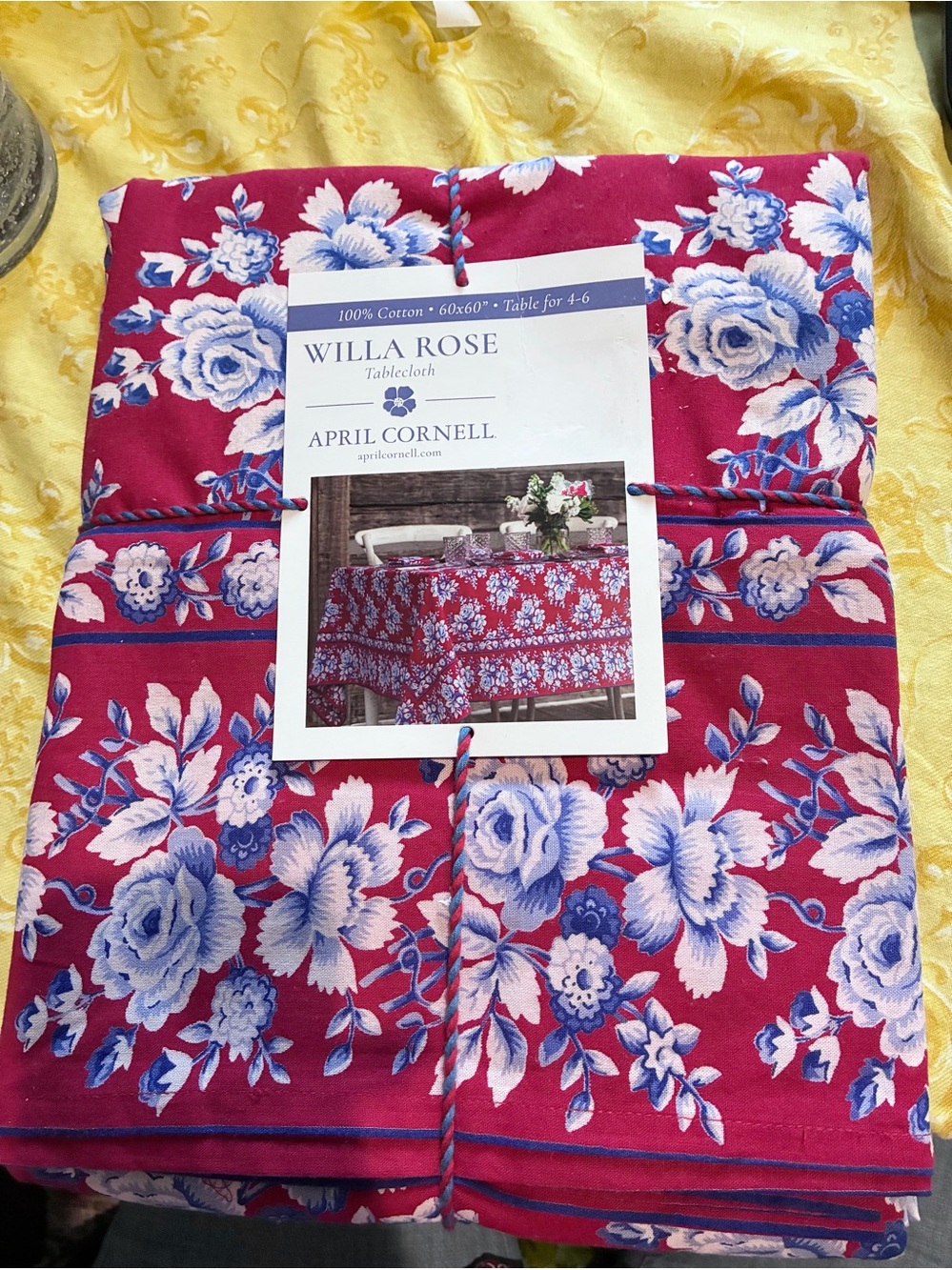 April Cornell Tablecloth. 60”x60”. New in package. Red background, blue & white